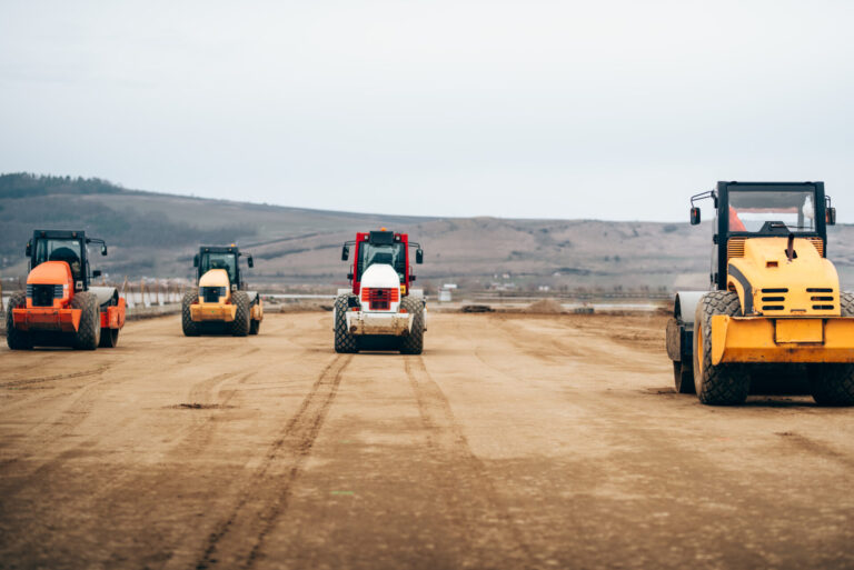Vibratory Compactor during road and highway construction. Industrial roadworks with heavy-duty machinery